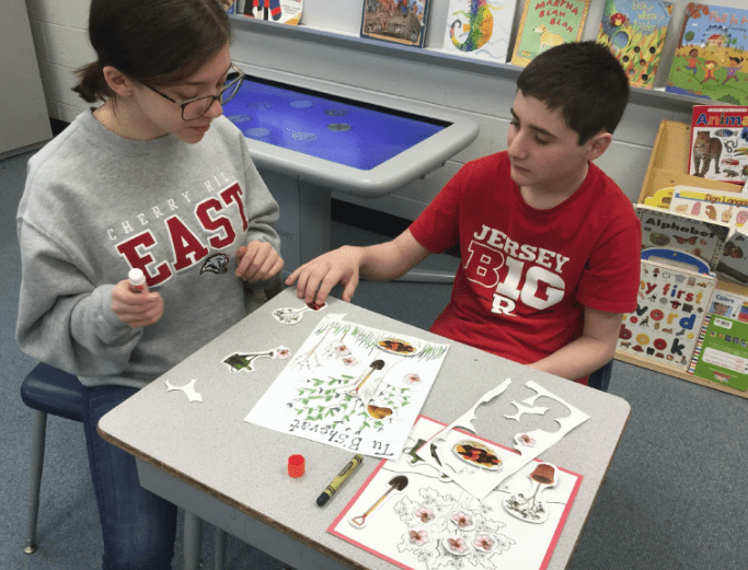 teacher working with a student