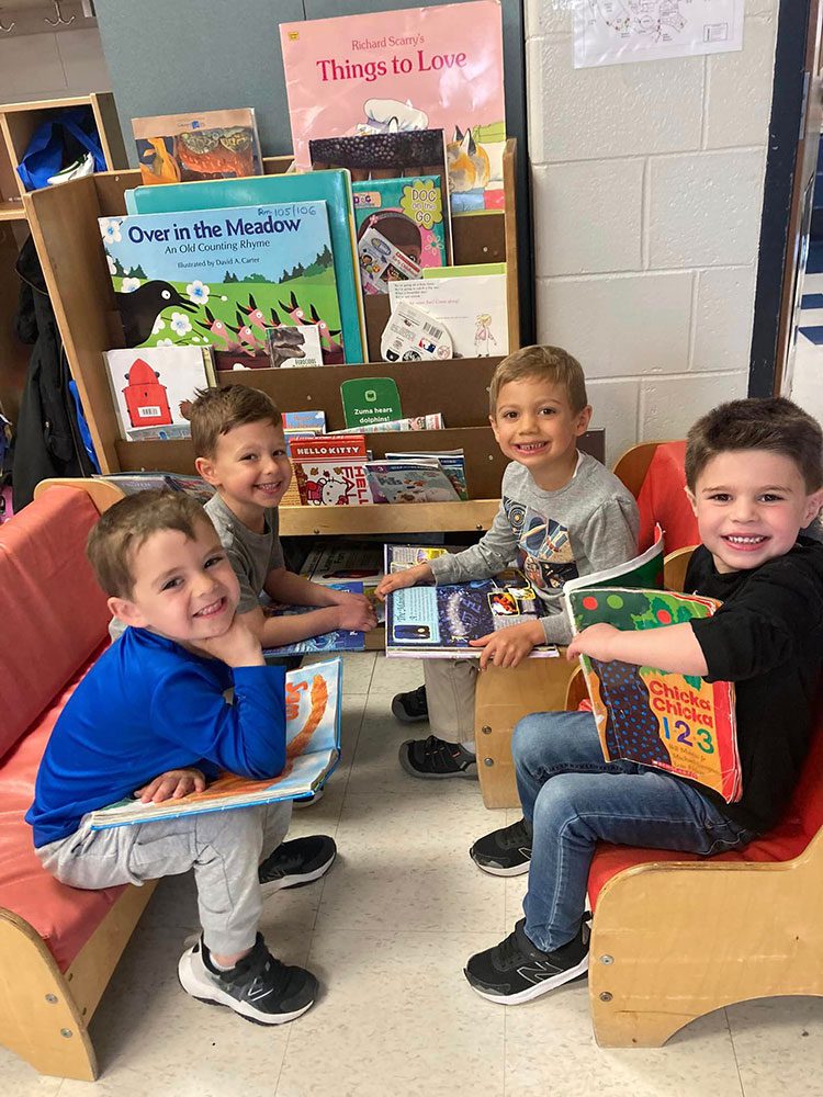 young boys sitting together reading