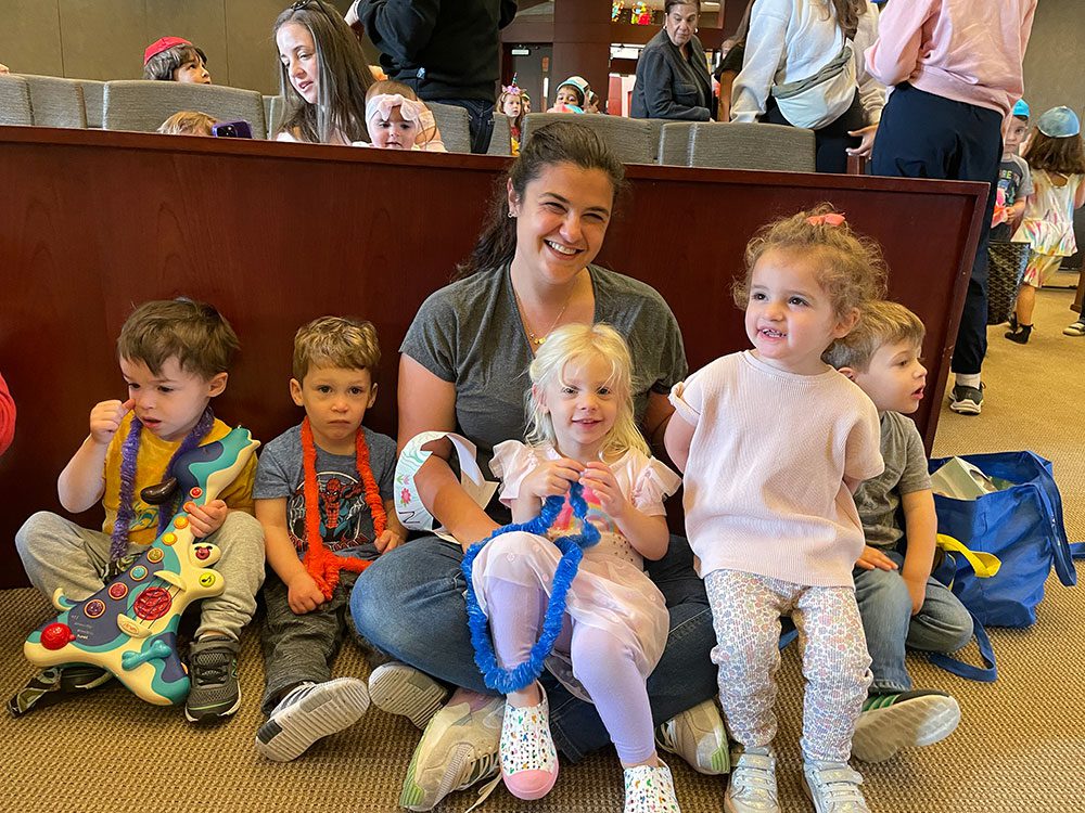 teacher sitting with young kids